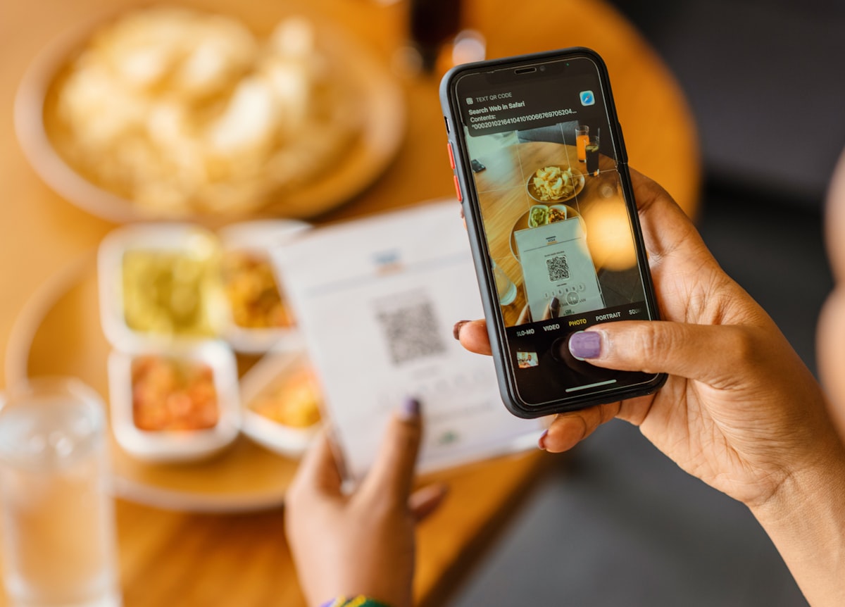 Customer scanning a QR code menu with their smartphone to place an order